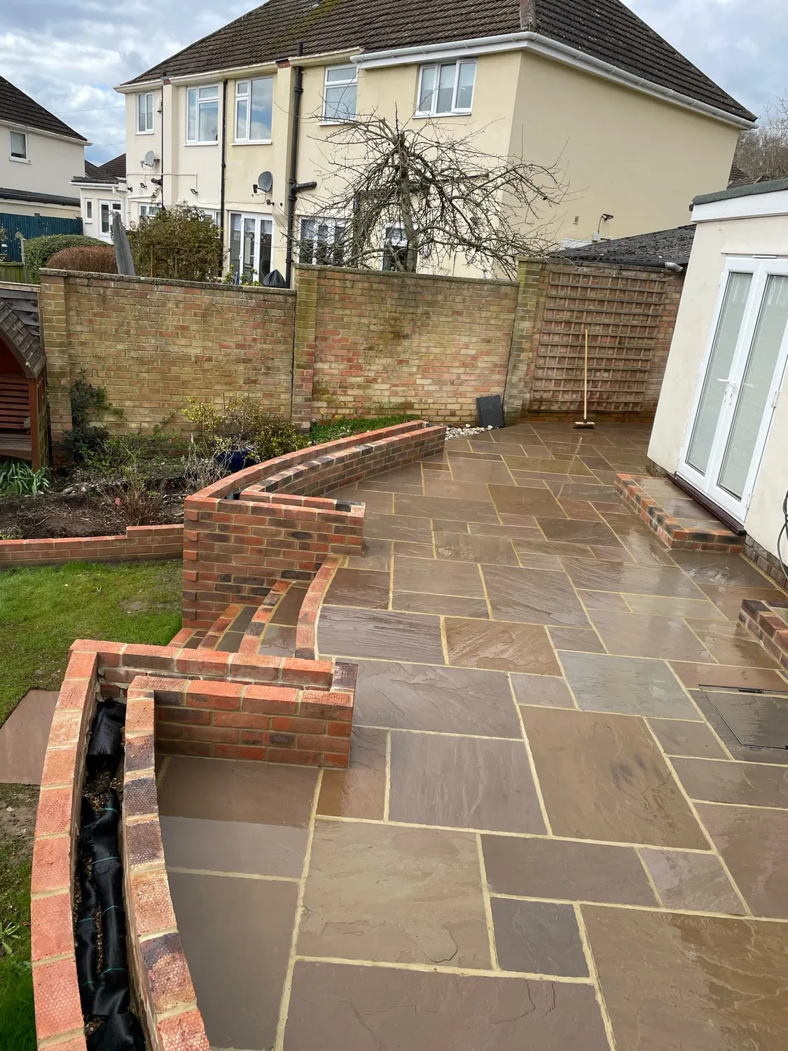 Patio with surrounding brickwork by Johnson Construction