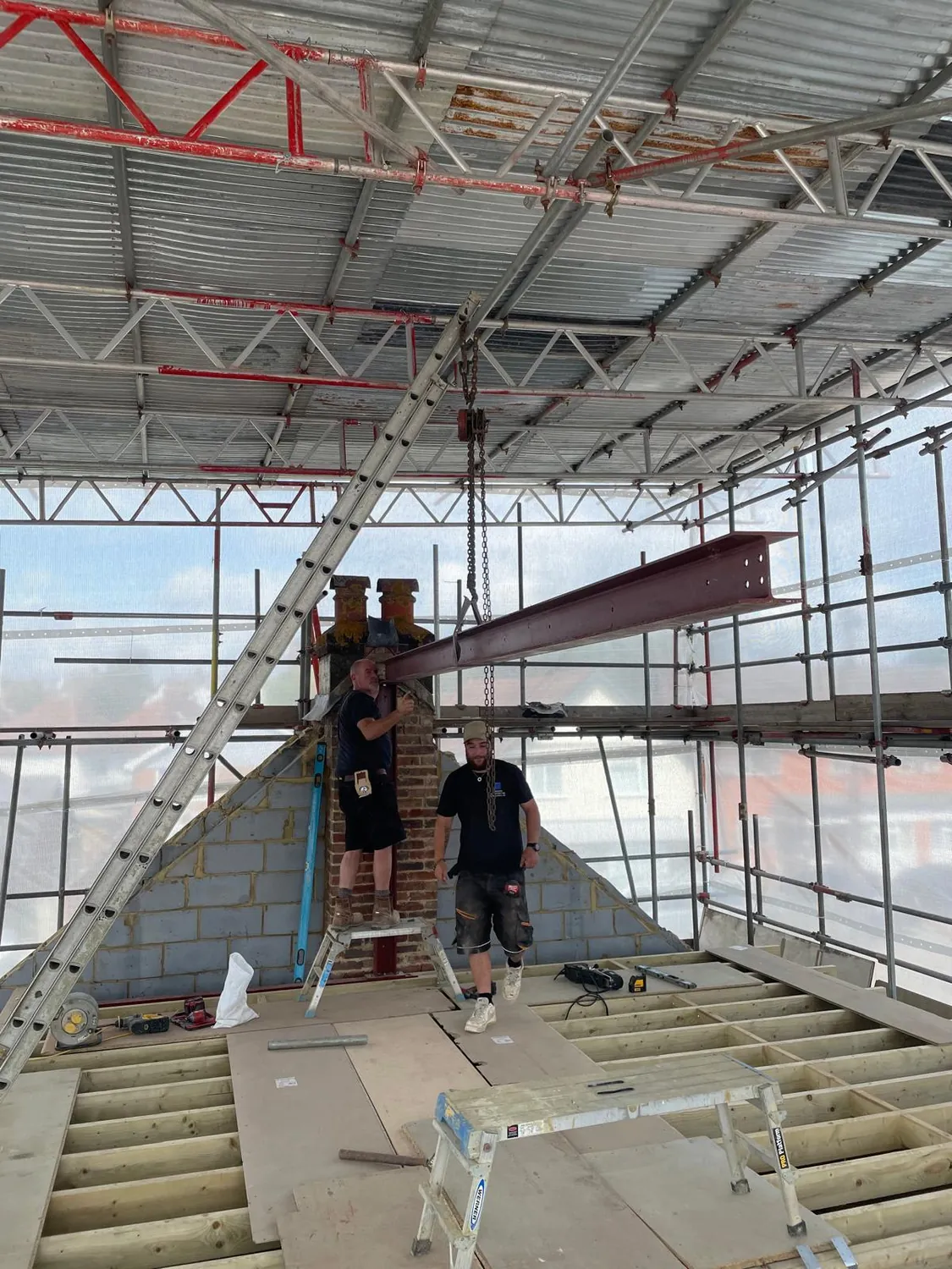 Steel beam being positioned by Johnson Construction